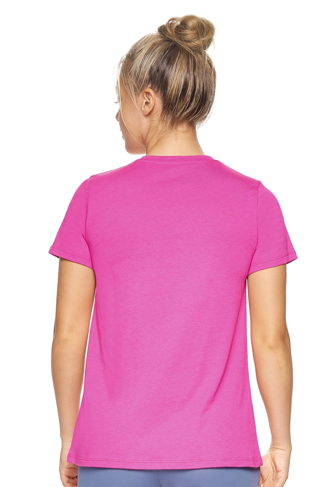 A female model with blonde hair wearing the Women's MoCA V-Neck Tee in the color berry, made from a luxurious blend of 50% LENZING Modal and 50% Combed Ring-Spun Cotton, showing the relaxed feminine fit from a back view. This fashion-forward, more sustainable t-shirt is elevated, eco-friendly, made in the USA, and available for bulk purchase. #berry