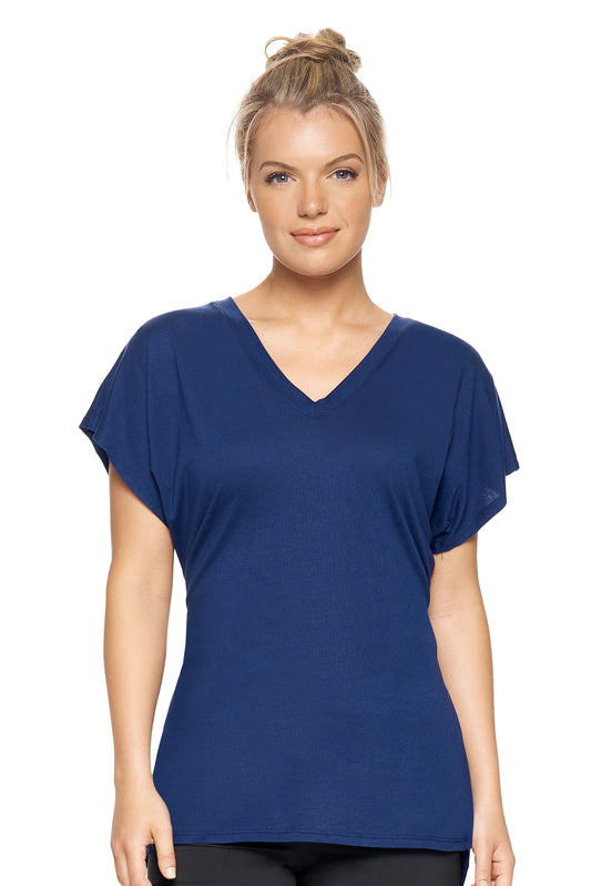 A female model with blonde hair wearing the women's MoCA V-Neck Cinch Back Tee in the color navy, made from a luxurious blend of 50% LENZING Modal and 50% Combed Ring-Spun Cotton, showing the relaxed fit from a front view. This fashion-forward, more sustainable t-shirt is elevated, eco-friendly, made in the USA, and available for bulk purchase. #navy