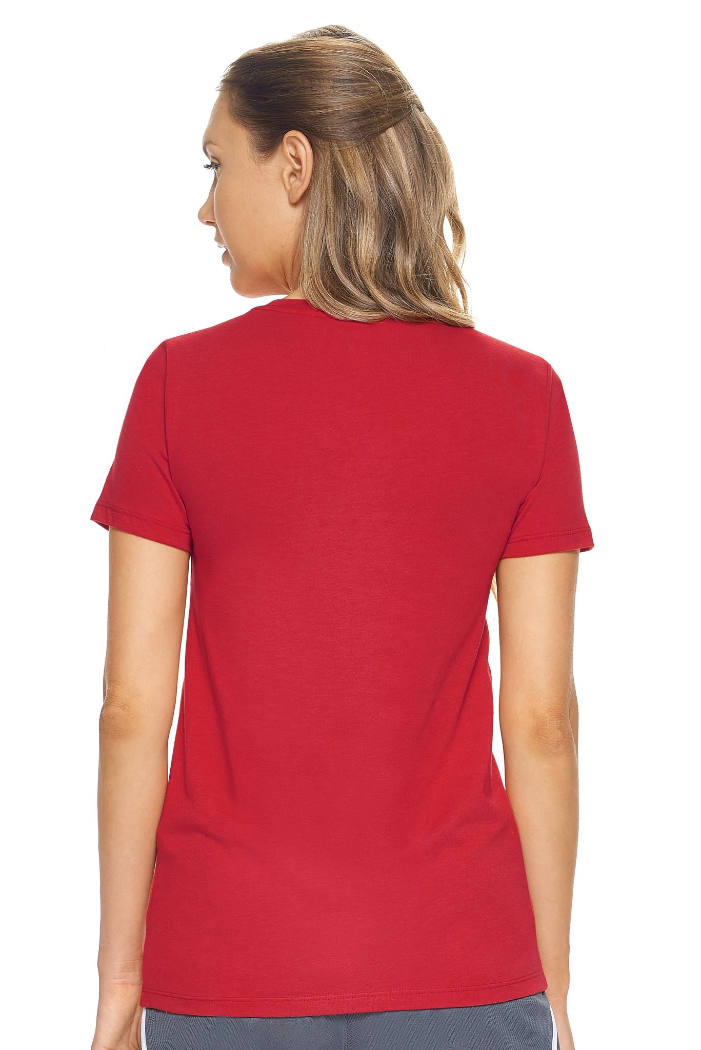 A female model with brown hair wearing the women's MoCA Bay Crewneck Tee in the color scarlet, made from a luxurious blend of 50% LENZING Modal and 50% Combed Ring-Spun Cotton, showing the feminine fit from a back view. This shirt is elevated, eco-friendly, made in the USA, and available for bulk purchase. #scarlet