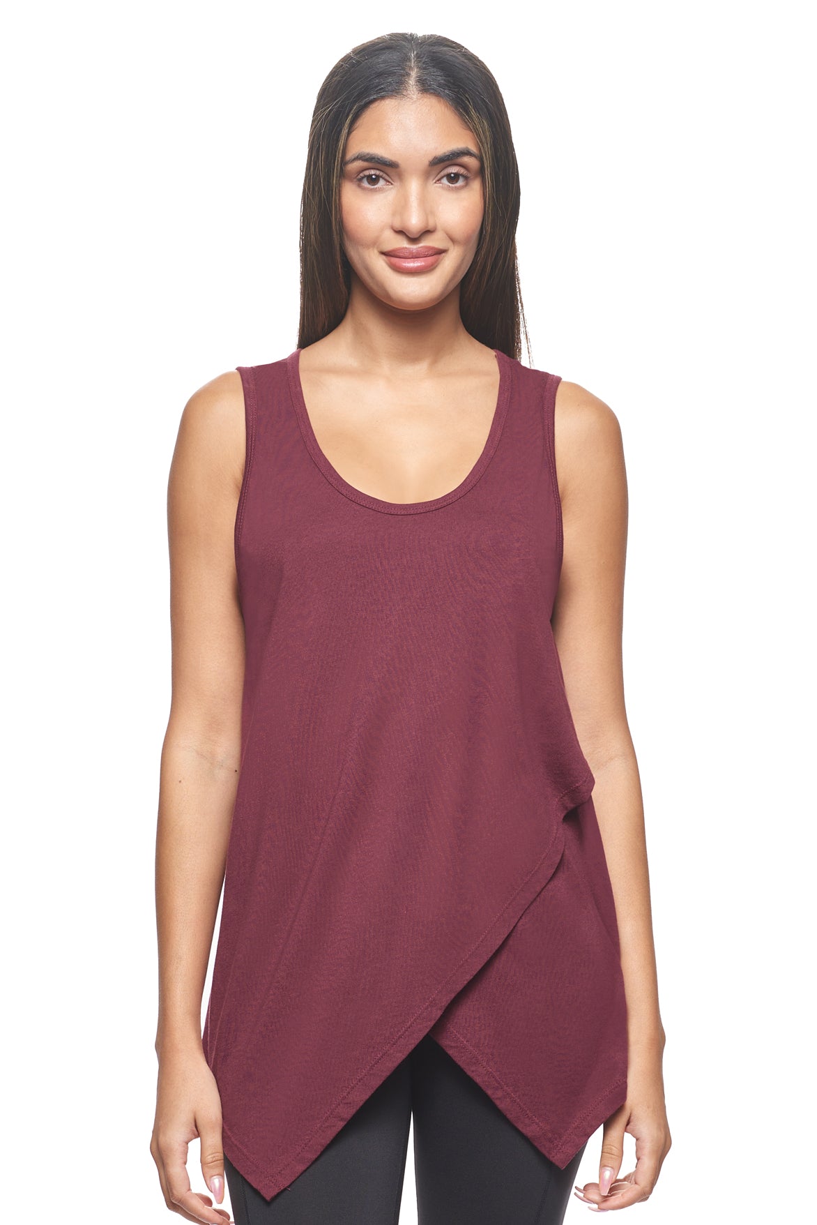 A female model with brown hair wearing the women's MoCA Tie Front Tank Tee in the color maroon, made from a luxurious blend of 50% LENZING Modal and 50% Combed Ring-Spun Cotton, showing the relaxed fit from a front view. This fashion-forward, more sustainable t-shirt is elevated, eco-friendly, made in the USA, and available for bulk purchase. #maroon