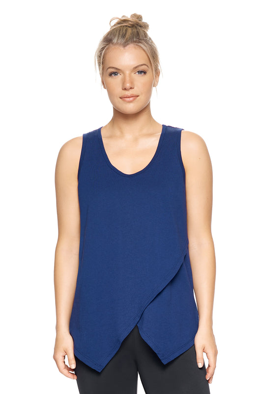 A female model with blonde hair wearing the women's MoCA Tie Front Tank Tee in the color navy, made from a luxurious blend of 50% LENZING Modal and 50% Combed Ring-Spun Cotton, showing the relaxed fit from a front view. This fashion-forward, more sustainable t-shirt is elevated, eco-friendly, made in the USA, and available for bulk purchase. #navy