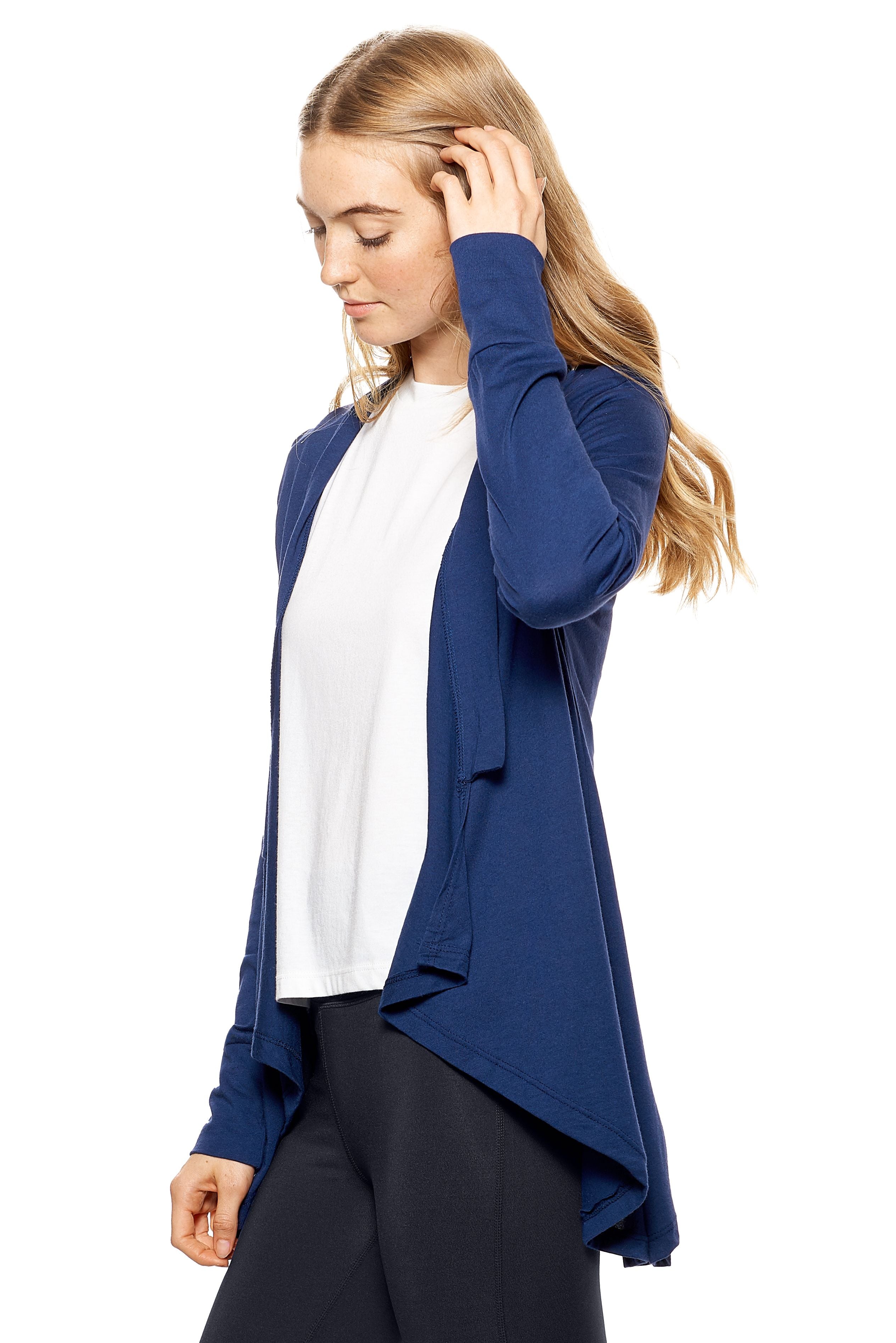 A female model with red hair wearing the women's MoCA Drape Front Cardigan in the color navy blue, made from a luxurious blend of 50% LENZING Modal and 50% Combed Ring-Spun Cotton, showing the relaxed fit from a side view. This fashion-forward, more sustainable top is elevated, eco-friendly, made in the USA, and available for bulk purchase. #navy