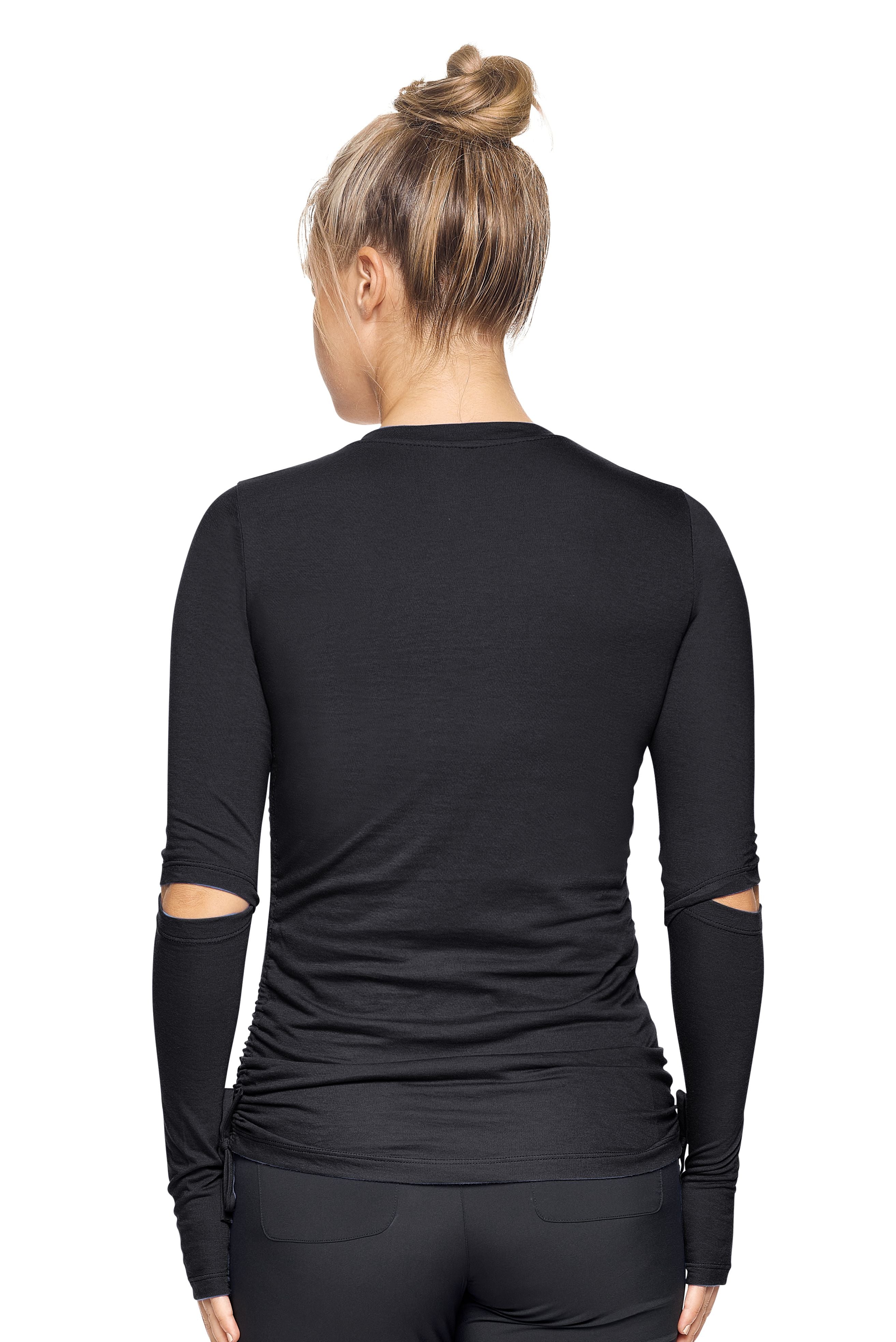 A female model with brown hair wearing the Women's MoCA Laurel Long Sleeve V-Neck Tee in the color black, made from a luxurious blend of 50% LENZING Modal and 50% Combed Ring-Spun Cotton, showing the feminine fit from a back view. This fashion-forward, more sustainable t-shirt is elevated, eco-friendly, made in the USA, and available for bulk purchase. #black