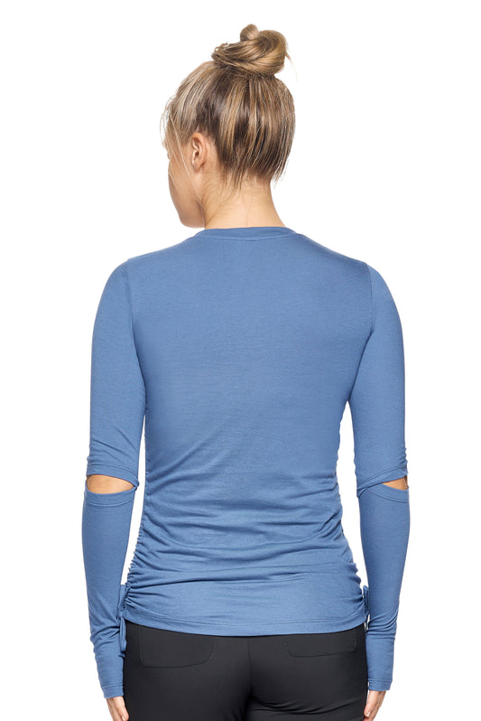 A female model with blonde hair wearing the Women's MoCA Laurel Long Sleeve V-Neck Tee in the color stone blue, made from a luxurious blend of 50% LENZING Modal and 50% Combed Ring-Spun Cotton, showing the feminine fit from a back view. This fashion-forward, more sustainable t-shirt is elevated, eco-friendly, made in the USA, and available for bulk purchase. #stone-blue