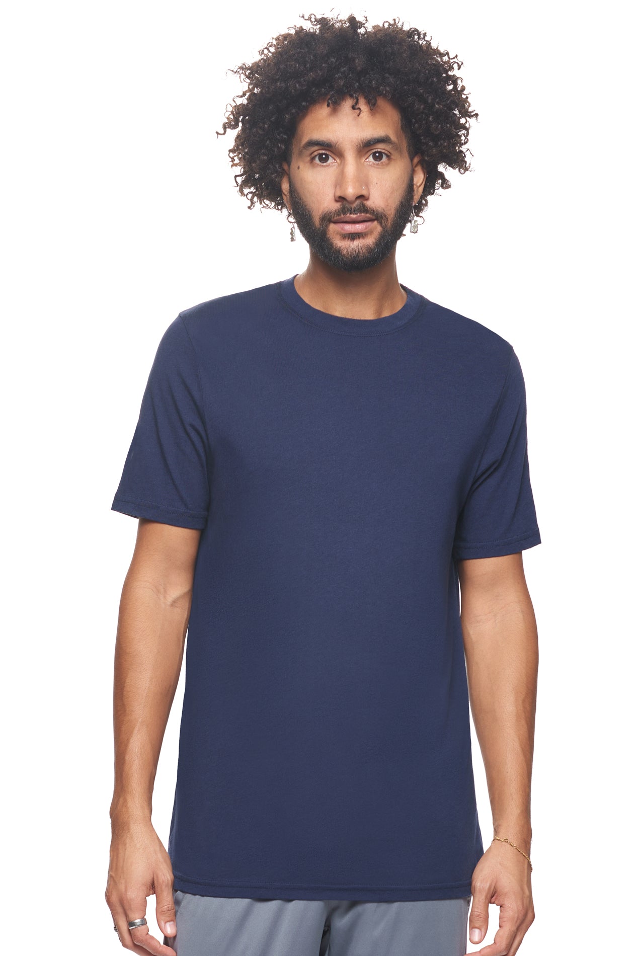 A male model with brown hair wearing the Men's MoCA V-Neck Tee in the color navy, made from a luxurious blend of 50% LENZING Modal and 50% Combed Ring-Spun Cotton, showing the relaxed fit from a front view. This fashion-forward, more sustainable t-shirt is elevated, eco-friendly, made in the USA, and available for bulk purchase. #navy