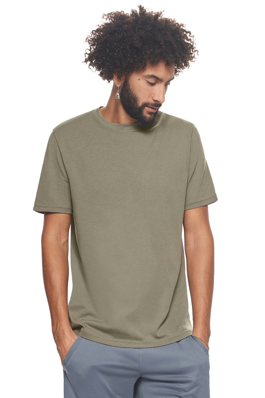 A male model with curly hair wearing the Men's MoCA V-Neck Tee in the color olive, made from a luxurious blend of 50% LENZING Modal and 50% Combed Ring-Spun Cotton, showing the relaxed fit from a front view. This fashion-forward, more sustainable t-shirt is elevated, eco-friendly, made in the USA, and available for bulk purchase. #olive