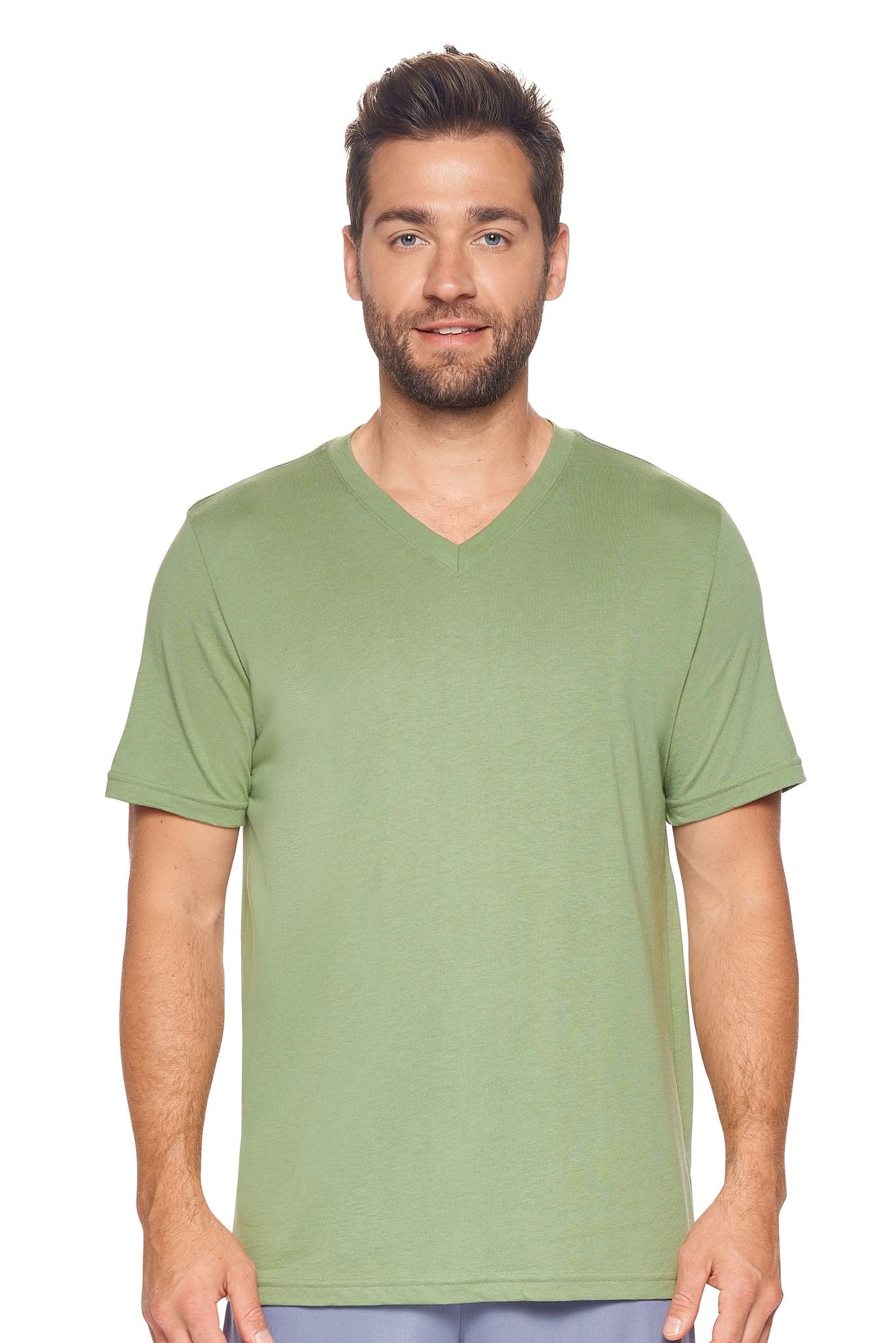 A male model with curly hair wearing the Men's MoCA V-Neck Tee in the color meadow, made from a luxurious blend of 50% LENZING Modal and 50% Combed Ring-Spun Cotton, showing the relaxed fit from a front view. This fashion-forward, more sustainable t-shirt is elevated, eco-friendly, made in the USA, and available for bulk purchase. #meadow
