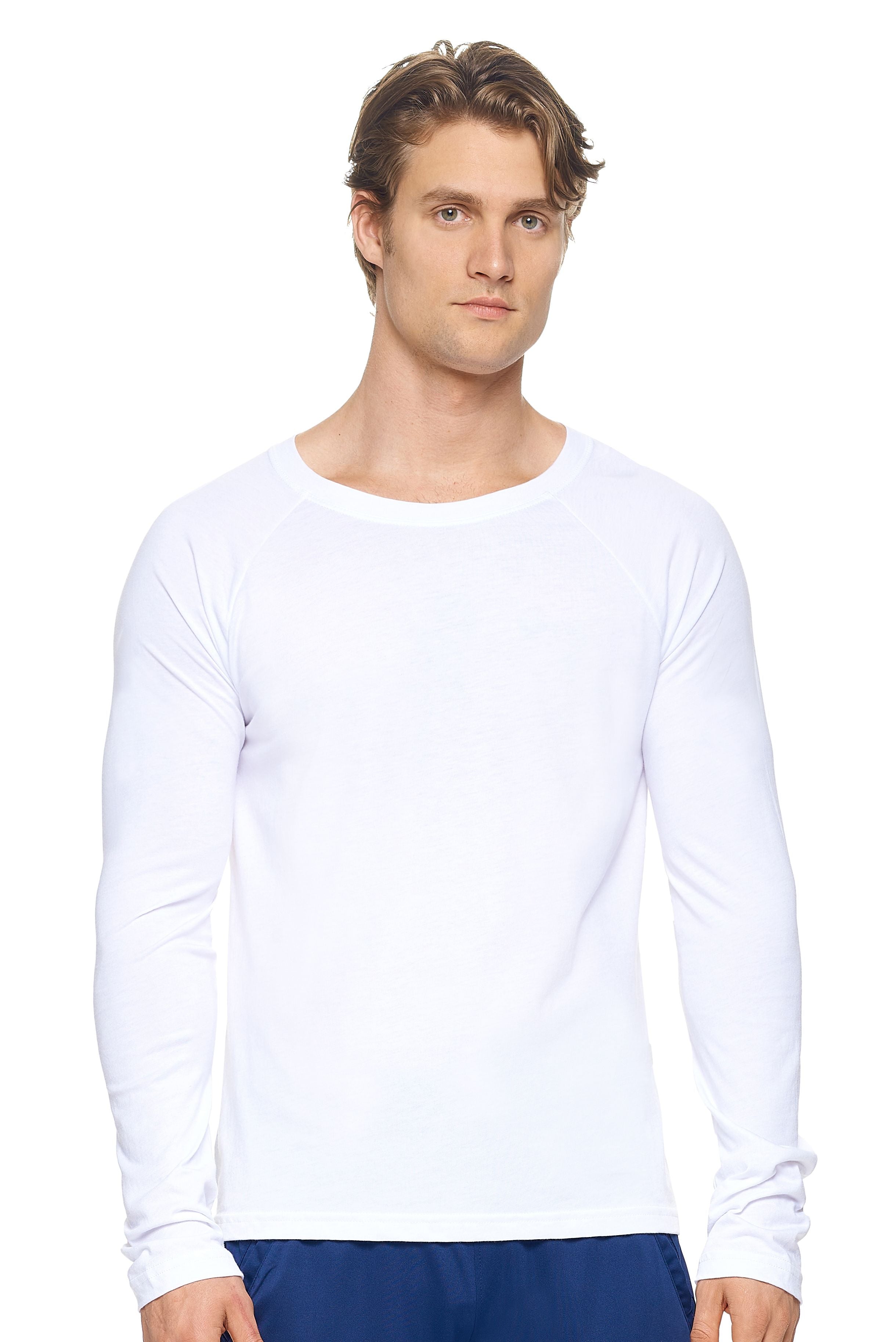 A male model with dirty blonde hair wearing the men's MoCA Long Sleeve Raglan Tee in the color white, made from a luxurious blend of 50% LENZING Modal and 50% Combed Ring-Spun Cotton, showing the relaxed fit from a front view. This shirt is elevated, eco-friendly, made in the USA, and available for bulk purchase. #white